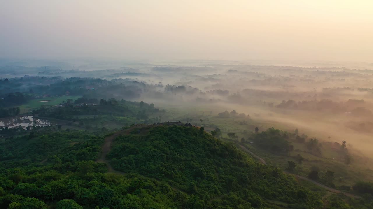 Behold the Enchanting Aerial View of a Foggy and Mystical Landscape