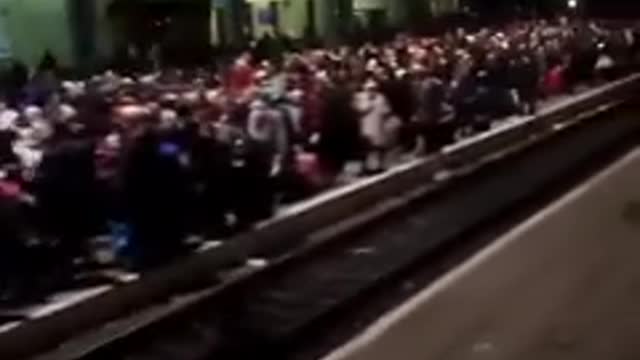 Ukrainian families are waiting for a train in Lviv to escape to Poland.