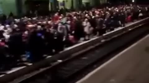 Ukrainian families are waiting for a train in Lviv to escape to Poland.