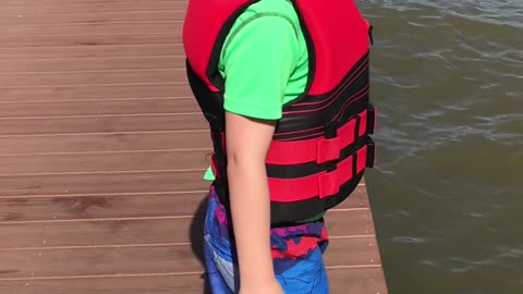 Kid Tries to Hype Himself Up to Jump Off Dock