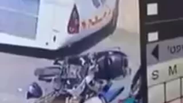 [HOLY...]- Two bike riders hit a parking bus real hard