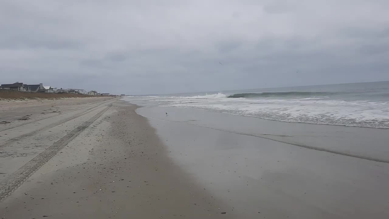 Walking along the beach in Pine Knoll Shores, NC