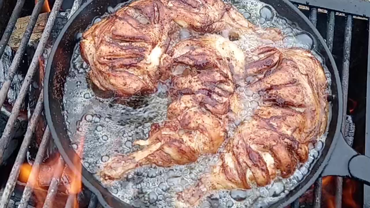 Outside - fried chicken legs in a cast iron pan