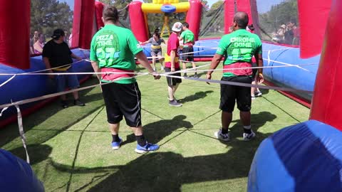 Playing soccer with players tied together.