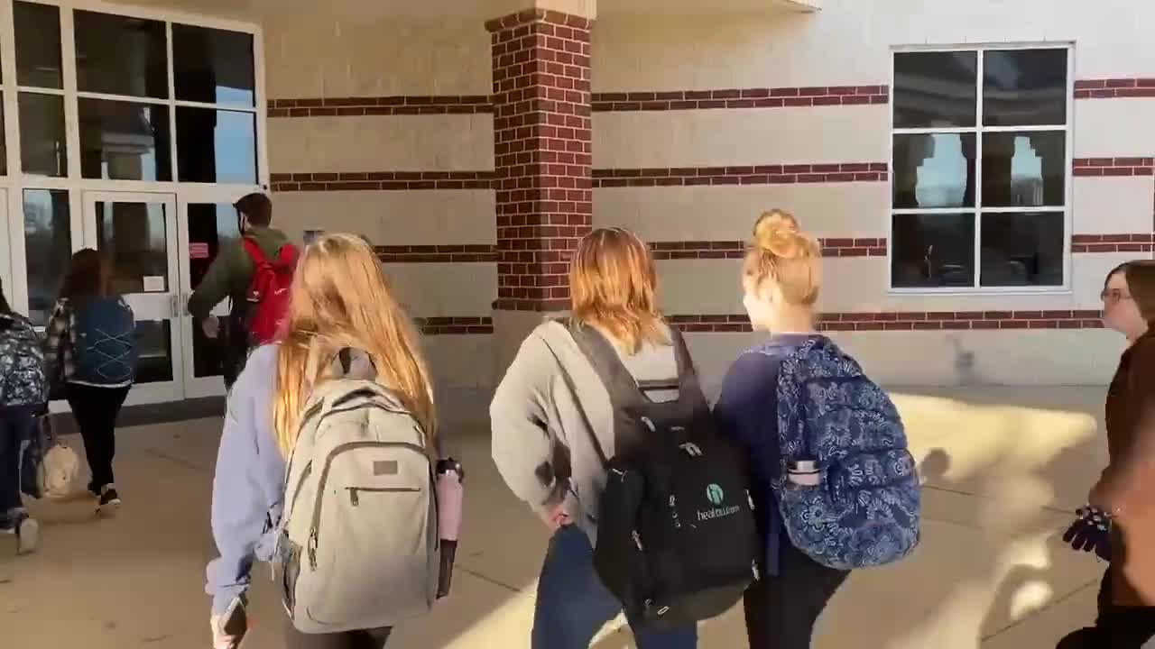 Students at Woodgrove High School in Loudoun County, Virginia walk into school without masks