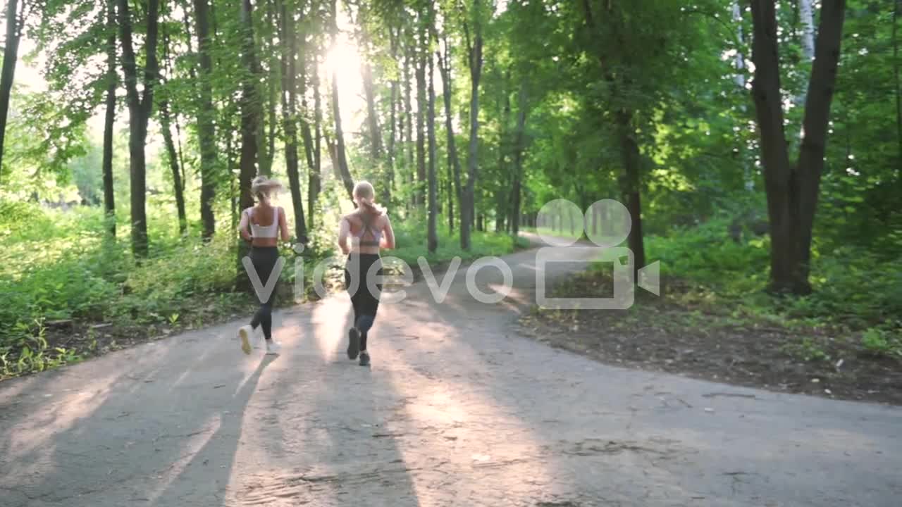 Pretty Blonde Girls Running In The Park In A Sunny Day