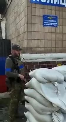 AFU troops remove the Russian sign on the police building in Lyman