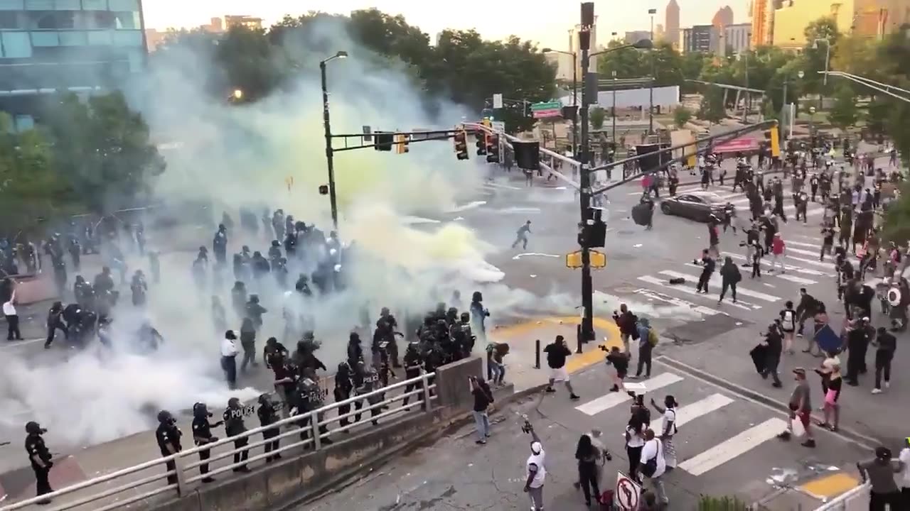 Atlanta Police fire teargas at protesters, wind blow smoke back in their direction.