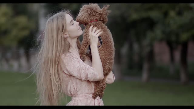 girl playing with cute puppy