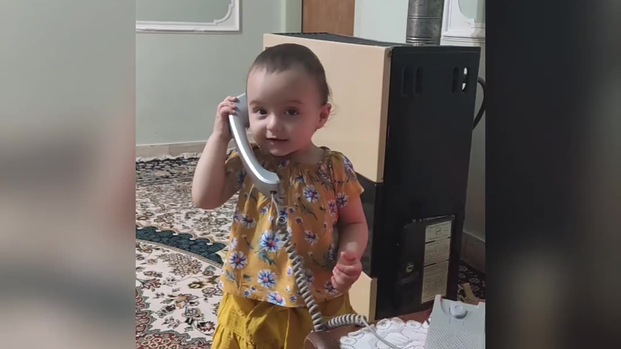 The child is surprised by the sound of the phone