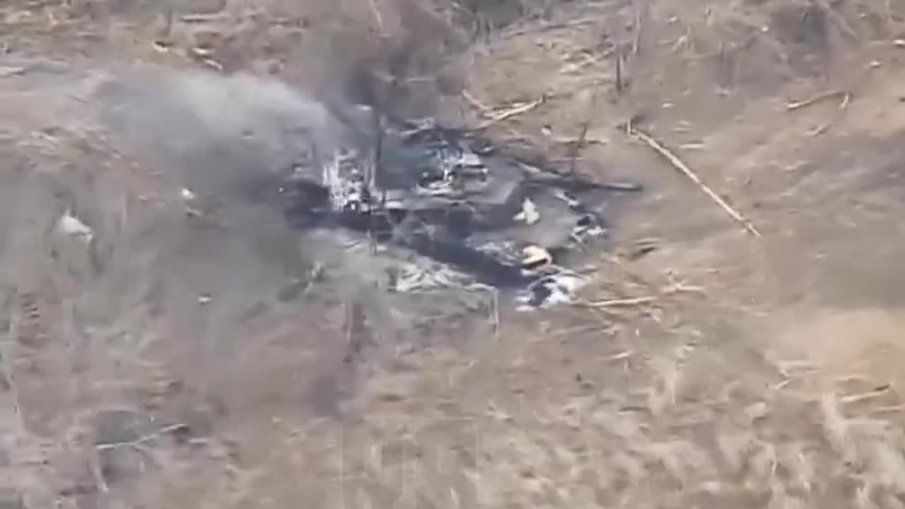 The fourth Abrams burned in a field.