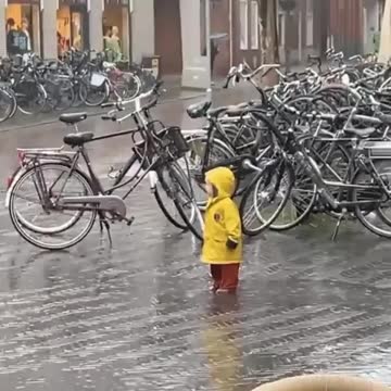 Cute Dutch children accepting the climate