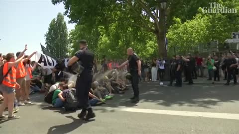 Police use pepper spray on seated climate protesters in Paris