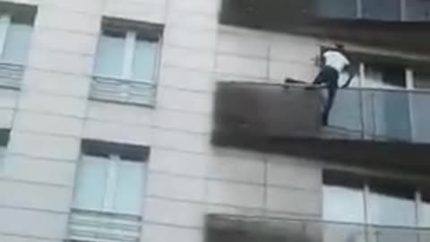 Man scales a building in Paris to save a child dangling from a 5th-floor balcony