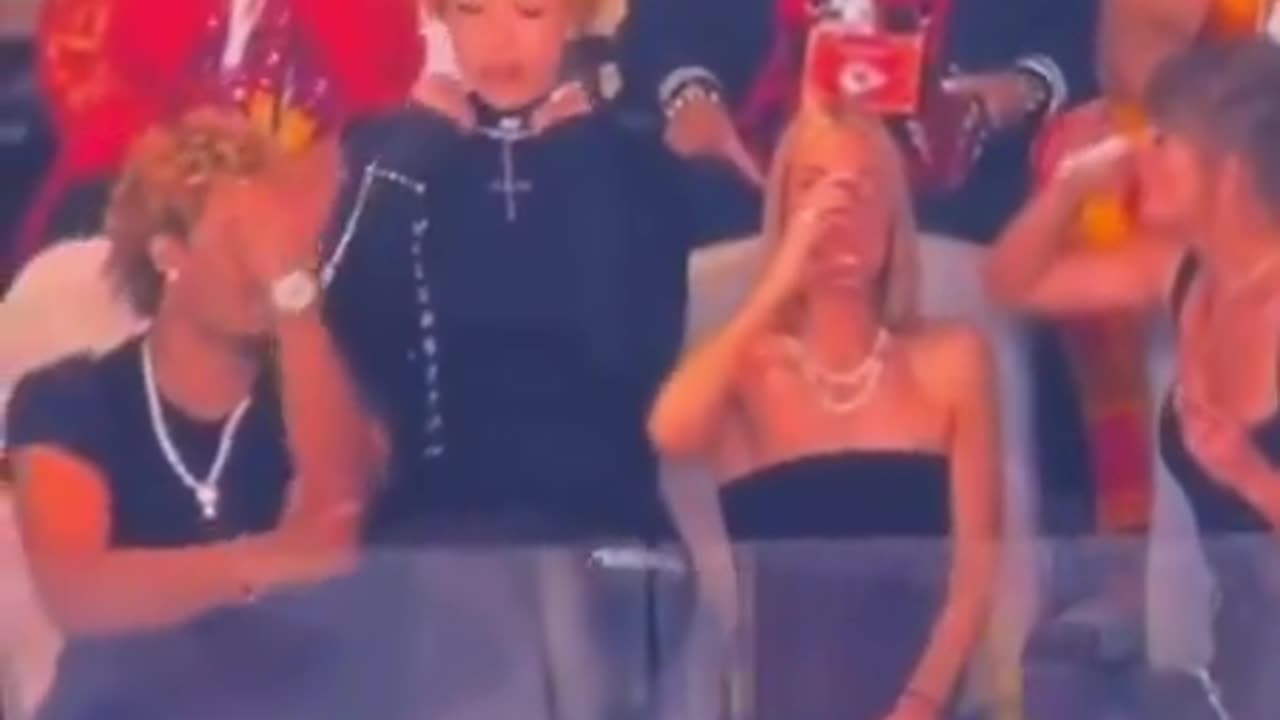 Taylor Swift's guest Ice Spice DEMONIC SIGN gestures while wearing upside down Cross at Super Bowl.