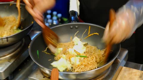 Asian Stir-Fried Noodles Cooking In Pan