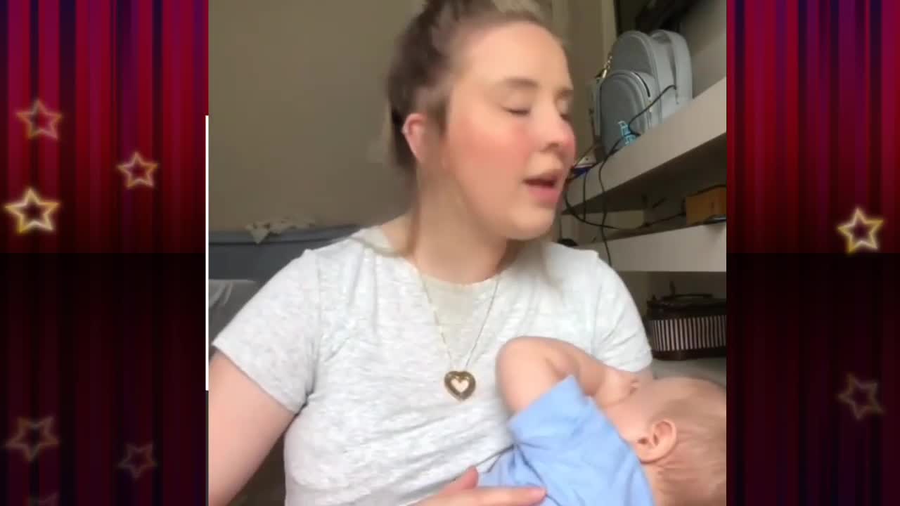 Baby Feeding mother milk. Mother singing a song