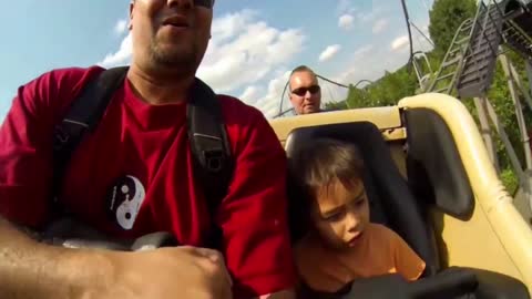 Little Boy Cringes During A Roller Coaster Ride