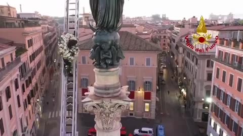 Italy - a firefighter places a wreath on a 88ft monument