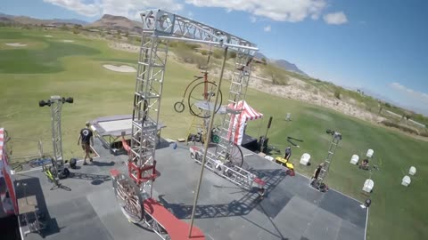 Circus Artist Warms Up While Riding Tall Bike Before Show