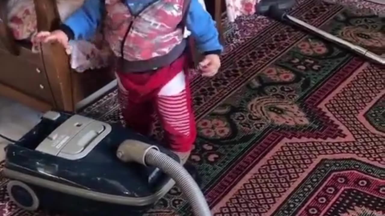 Little boy helps mom with the vacuuming! Love this! Funny!