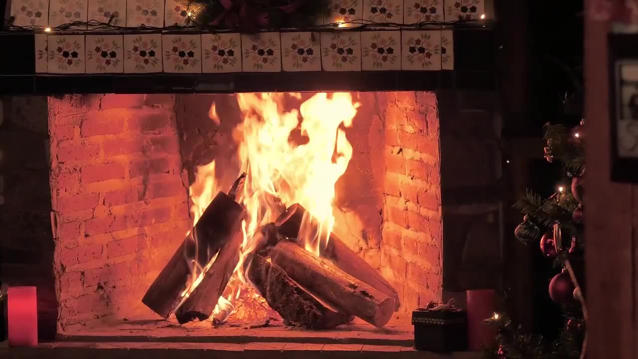 A fireplace lit at Christmas time