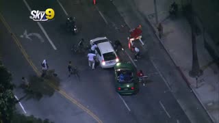 Rioters in Los Angeles (Hollywood) attack a driver on the road