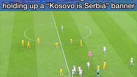 Romanian fans chant "Serbia" while holding a "Kosovo is Serbia" banner.