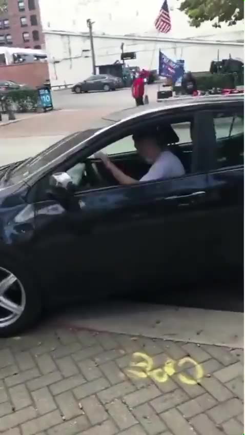 Man crashes car after trying to take TRUMP flag from supporter