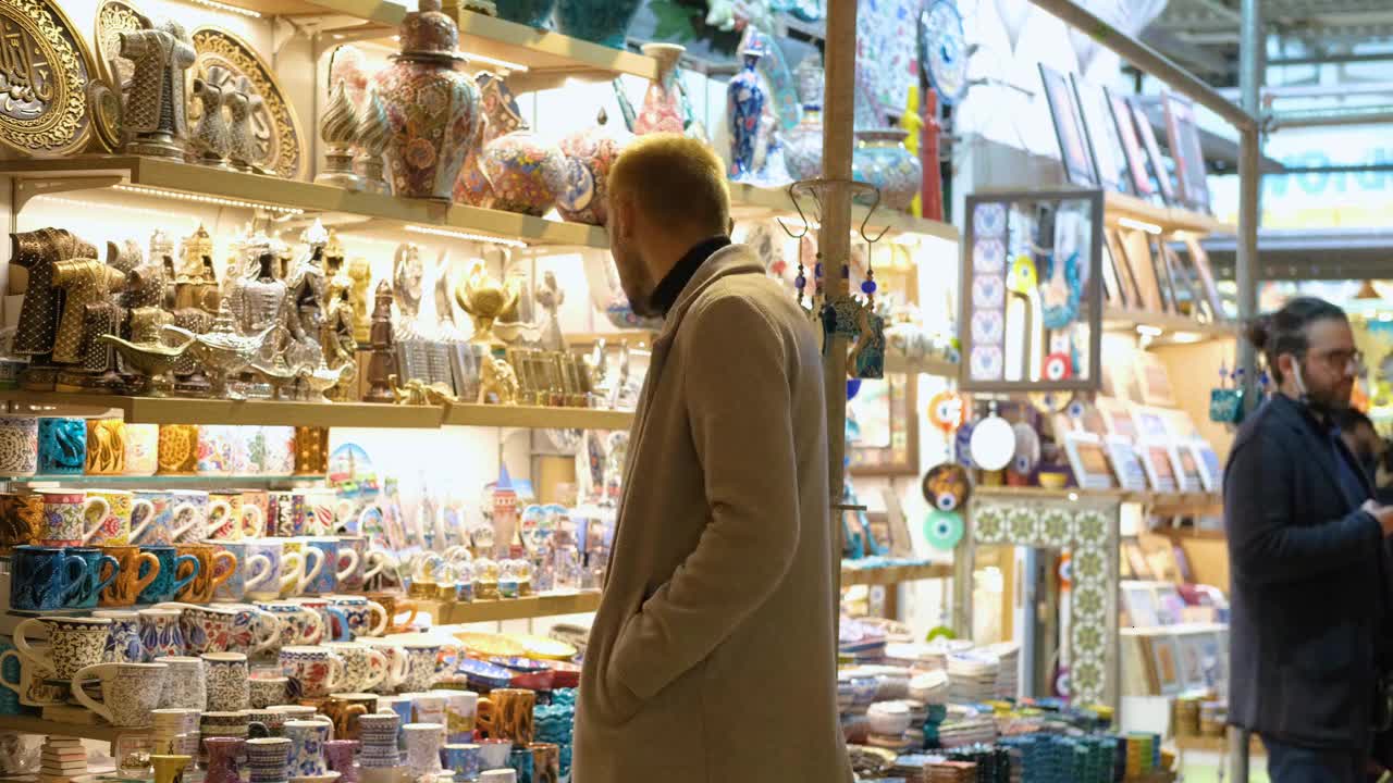 Wide Shot of Man Looking at Cups