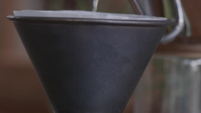 person making drip coffee