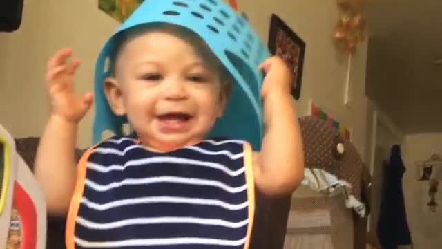 this baby puts the grocery basket on his head laughing