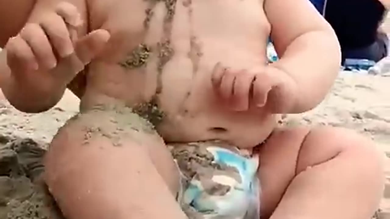 Cute baby reaction on the beach