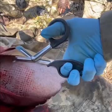 Ukrainian Medic Examining a Soldier Shot in the Leg