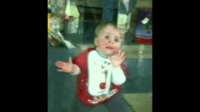 Kid trying to wipe the glass clean