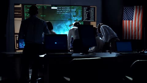 People working in space mission control center