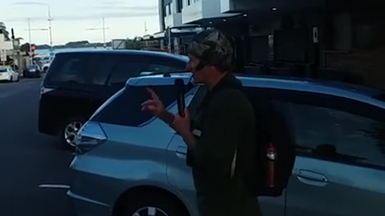 Angry heckler grabs street preacher around the neck while preaching at Tauranga