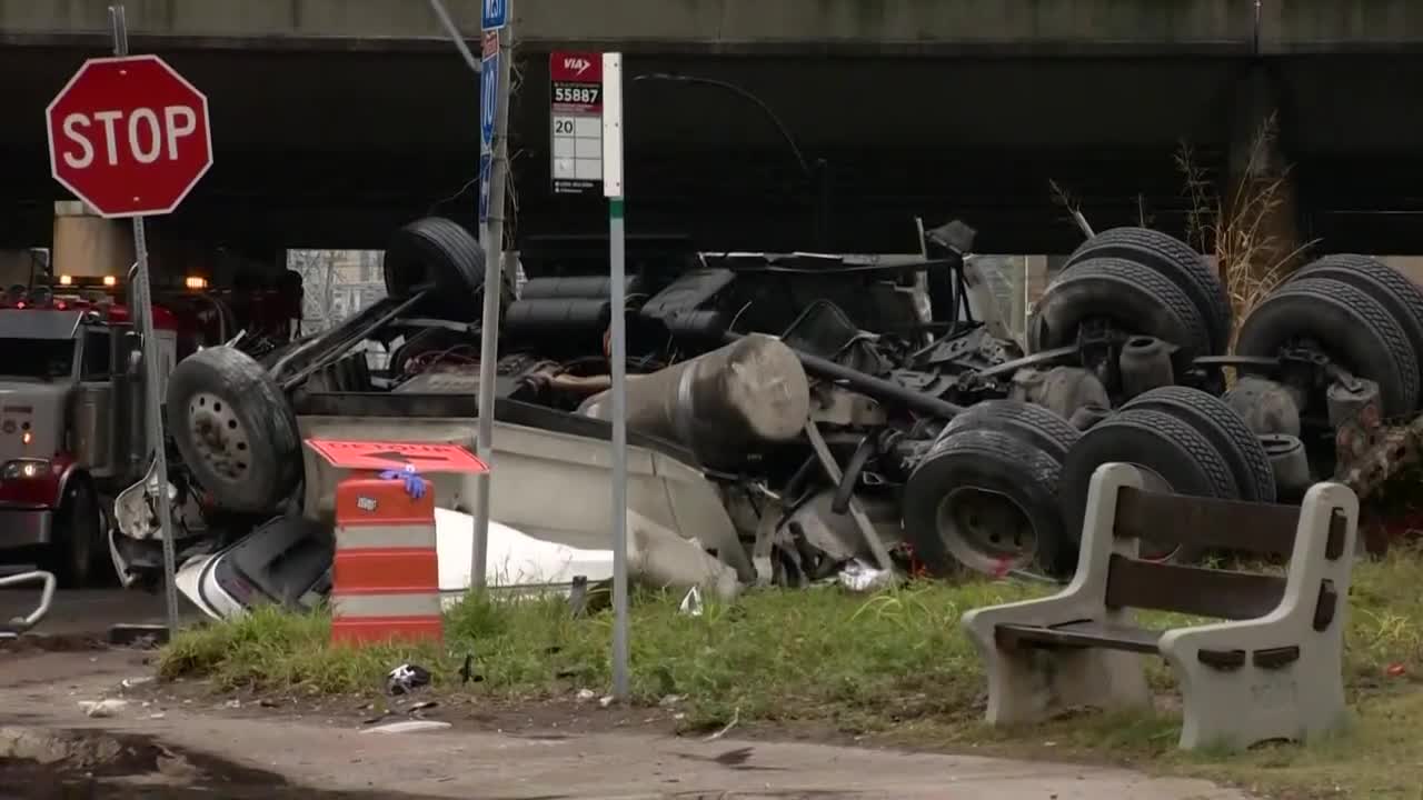 18-wheeler crashes off highway, lands on lower level 13 feet below