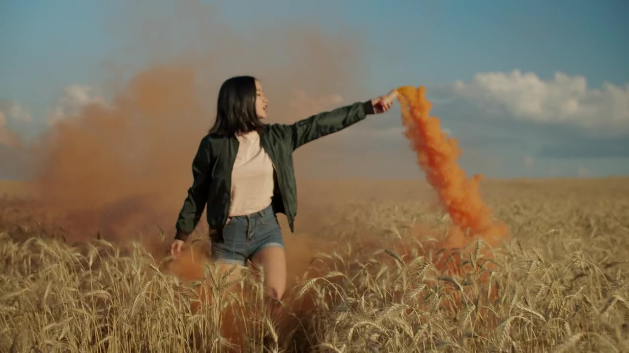 Happy girl jumping with a smoke flare