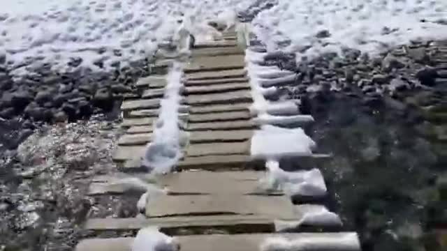 .Person Shows Snow-covered Mountains And Clear Stream In Spiti Valley, India