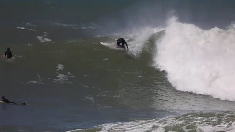 A Surfer Takes off and Crashes Into Another