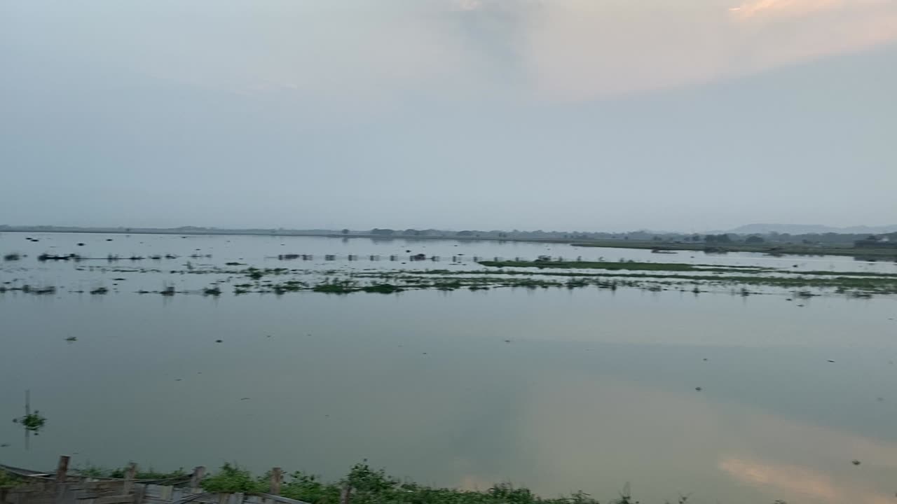 A river with an ancient bridge in Burma