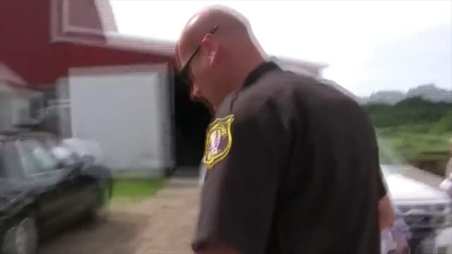 Vernon Hershberger rejects a search warrant for his raw milk farm in Wisconsin