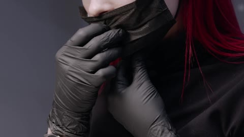 A Manicurist With Red Hair Wear A Face Mask Before Doing A Nail Polish Service To A Client