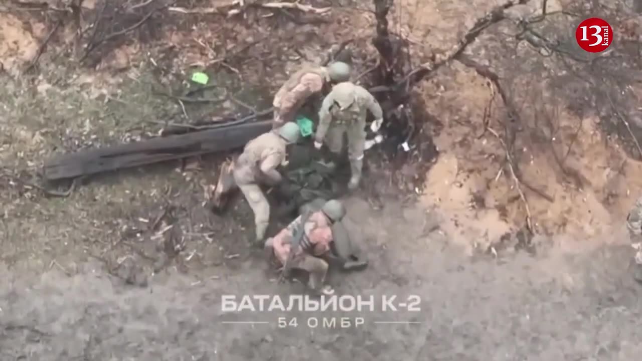 Ukrainian fighters put the wounded and captured