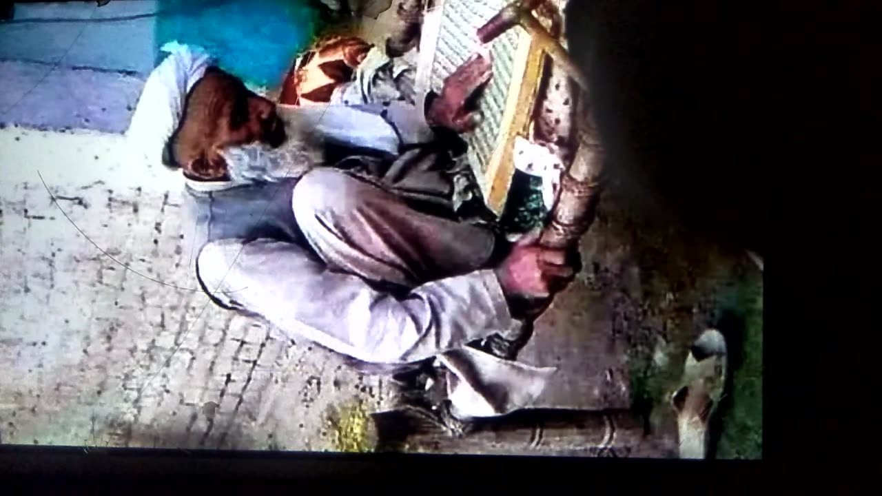 Old man buzy in reciting Quran e. Paki