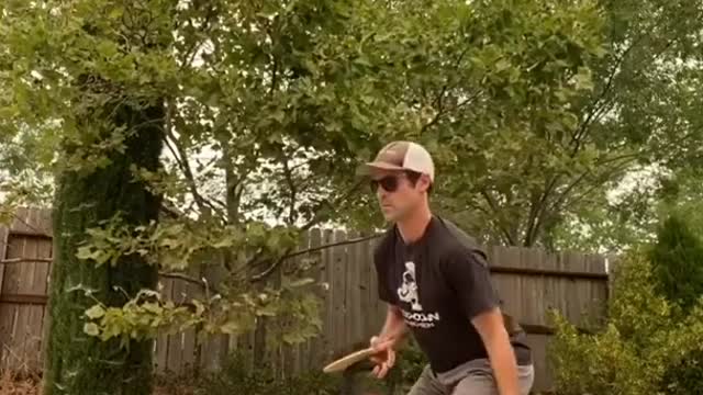 Guy Plays Ping Pong and Does Weightlifting While Balancing Himself Over Slackline