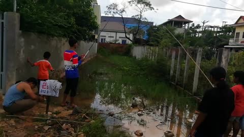 Kids fishing in flooded lot