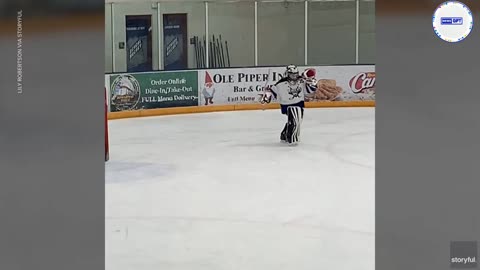 Young hockey goalie performs a moonwalk during a break in the action