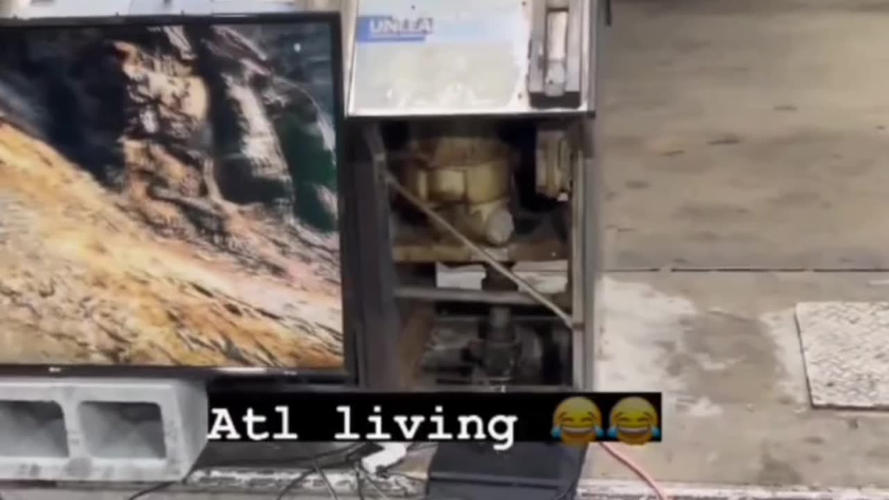 Atlanta: Homeless squatter sets up his living room in front of a gas station.